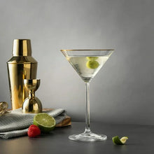 Gold-rim martini glass with clear bowl, lime and berry garnish on stem