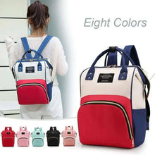 Blue and white diaper backpack with red front panel and adjustable shoulder straps