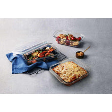 Lidded rectangular glass bake dishes with clear lids, various foods
