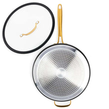 Black non-stick sauté pan with perforated lid insert and gold handle