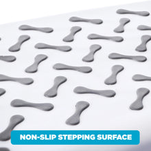 Close-up of white step stool tread with gray non-slip grip knobs