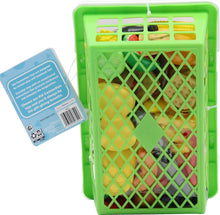 Green shopping basket with attached info card and assorted plastic food pieces.