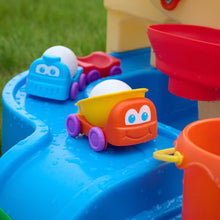 Toy water slide track with orange and blue character boats and red bucket