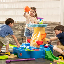 Blue water play center with yellow chute and colorful cups, children playing