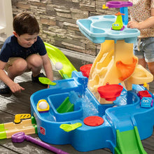 Outdoor blue water play center with yellow chute, splash feature, and toy cups