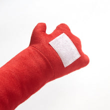 Red plush slumber bag accessory with stitched white label patch