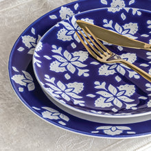 Indigo blue round dinner plate with white floral pattern and wide decorative rim