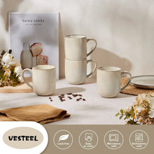 Ceramic coffee mug set with handles, cream finish, arranged on a table