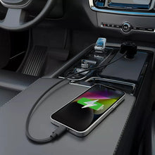 Car dual-port charger connected to a smartphone with retractable USB cable