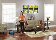 Blue canister vacuum cleaner on wheels with upright floor attachment