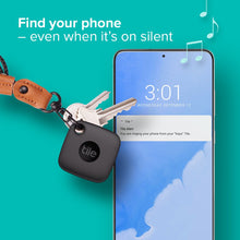 Black Tile tracker tag on a keyring near a smartphone screen