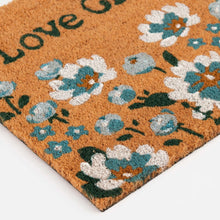 Folded-corner outdoor doormat with blue and white flowers on brown pile