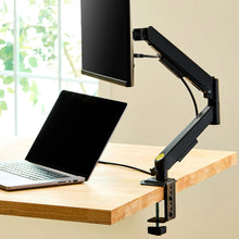 Black spring-assisted monitor mount attached to desk with adjustable arm