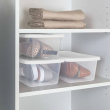 Clear plastic storage bins with white snap-on lids on closet shelf, storing shoes