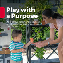 Kids playing beside an outdoor toy kitchen set with pretend herbs