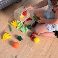Pretend food pieces and toy kitchen accessories scattered while kids play