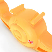 Close-up of orange snail seesaw toy with spiral shell and small badge
