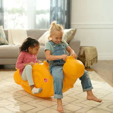 Orange snail seesaw toy with two children balancing while sitting on it
