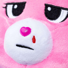 Pink plush bear face with white muzzle, pink nose, and heart detail