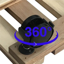 Close-up of black caster wheel and circular locking plate on wooden base.