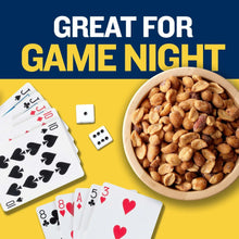Bowl of honey roasted peanuts with playing cards on a yellow background