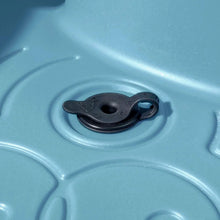 Close-up of blue plastic water table drain outlet with black stopper