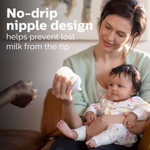 Philips Avent baby bottle with no-drip nipple, held near a baby