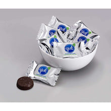 York Zero Sugar peppermint patty candies in a white bowl with wrapped dark pieces