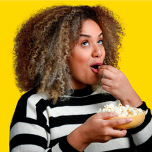 White cheddar flavored popcorn snack being eaten from a small bowl