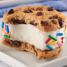 Chocolate chip cookie sandwich with white filling and colorful sprinkle decoration