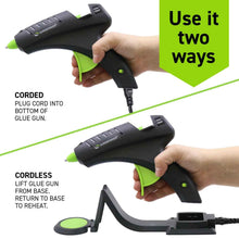 Black and green hot melt glue gun on stand with green glue pad
