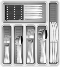 Stainless steel utensils arranged in a compartmentalized gray organizer tray