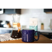 Blue Cameron's coffee mug with handle on a wooden table