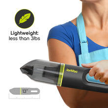 Green cordless handheld vacuum held in hand, compact size and clear dust cup