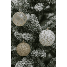 Shatterproof Christmas ornaments on tree: gold grid, white patterned, and gold glitter balls