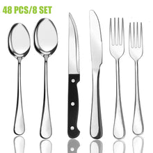 Stainless steel flatware set featuring spoons, forks, and black-handled steak knives