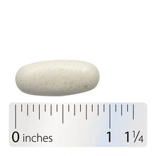 White oval tablet next to ruler, about 1 1/4 inches long