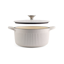 Cream enameled cast iron dutch oven with lid, ribbed sides, loop handles.