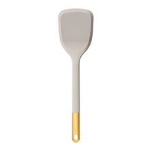 Silicone spatula utensil in gray with gold-tone handle and hanging loop