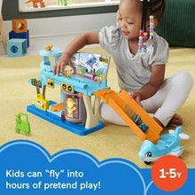 Toddler using blue airport playset with orange jet bridge, airplane toy, and figures