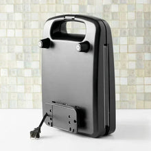 Black 4-slice waffle maker back view with power cord and outlet