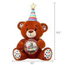Tan bear plush sitting, rainbow party cone hat and glowing music globe on its belly.