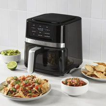 Black digital basket air fryer with viewing window and front handle, with nachos and salsa
