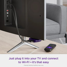 Streaming media player connected to TV with Wi-Fi cable and remote nearby