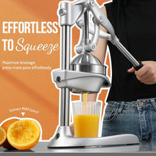 Hand-operated manual juicer with long lever pressing fruit over a juice cup