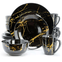 Black porcelain dinnerware set with gold veined marble pattern, stacked plates and mugs