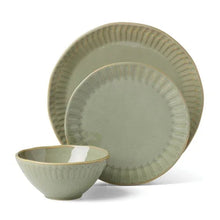 Green stoneware bowls and dinner plates with ridged edges, service set