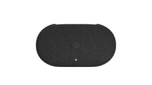 Black streaming device with oval top and small LED indicator