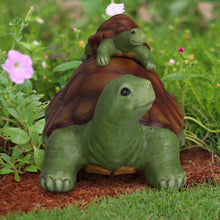 Garden turtle figurine with baby turtle on top, green body and orange-brown shell