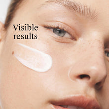 Neutrogena face moisturizer on skin with white cream dots on cheek and under eye